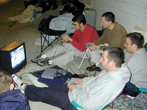 A group of guys outside Best Buy playing PS1 while waiting in line for the greatly anticipated Playstation 2. (2000)
