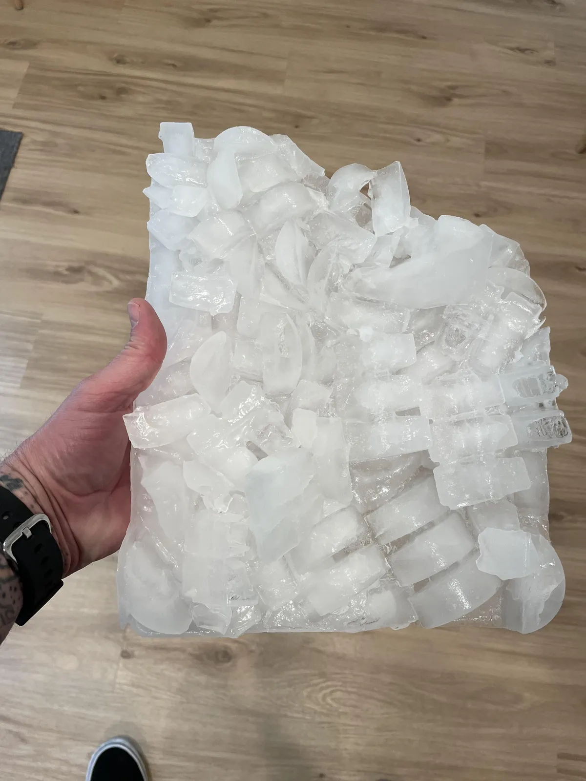 Why do I have to remove a sheet of ice from my refrigerator/freezer’s ice tray every week?