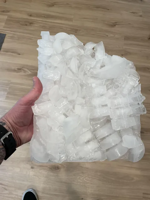 Why do I have to remove a sheet of ice from my refrigerator/freezer’s ice tray every week?