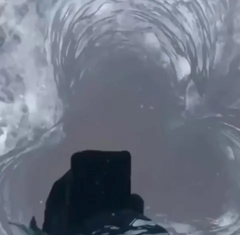 Man captures a seal surfacing to breathe while filming an Artic hole