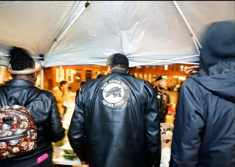 Armed members of the Black Panther Party walk through downtown and join protest [OC]
