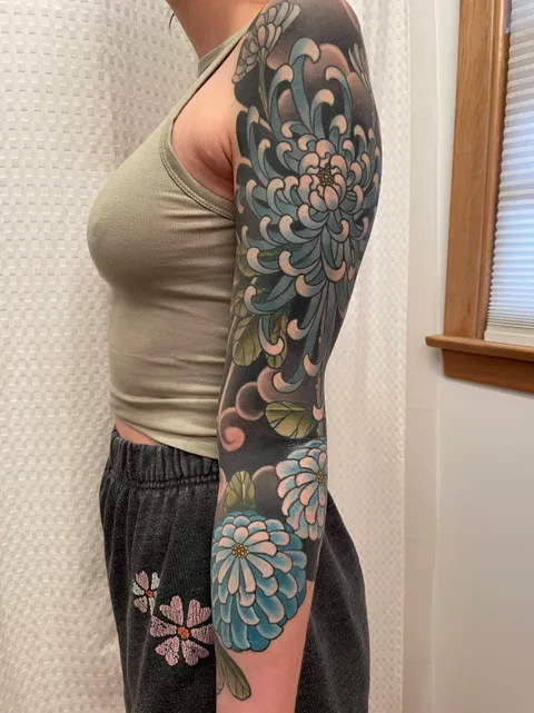 Finished chrysanthemum sleeve by Travis Hulshizer at Red Fern Tattoo in Kansas City