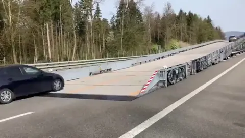 In Switzerland, a mobile overpass bridge is used to carry out road work without stopping traffic