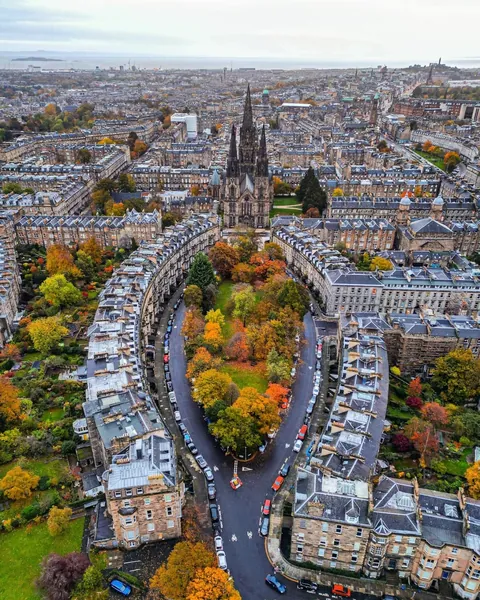 Grosvenor and Lansdowne Crescent Gardens surrounded by late 19th-century Georgian and Regency-style town houses and the 1879 Victorian Gothic Revival St Mary's Episcopal Cathedral, West End of Edinburgh, Scotland.