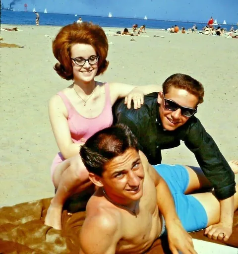 Lady poses at the beach with some friends, 1960s.