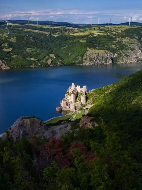 The Golubac fortress in Serbia, and wind turbines in Romania