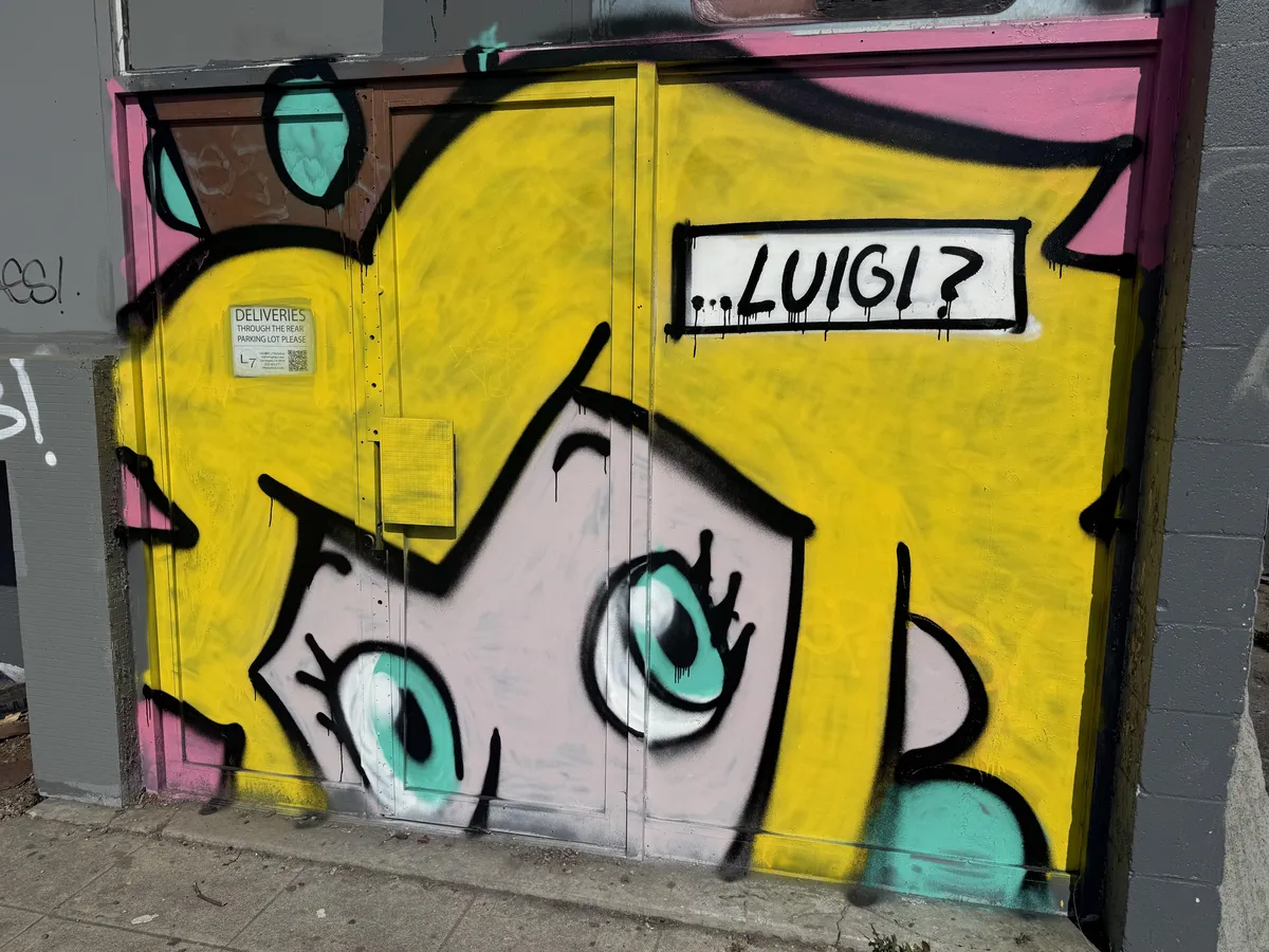 Local graffiti left the building occupant’s notice for deliveries visible through the glass.