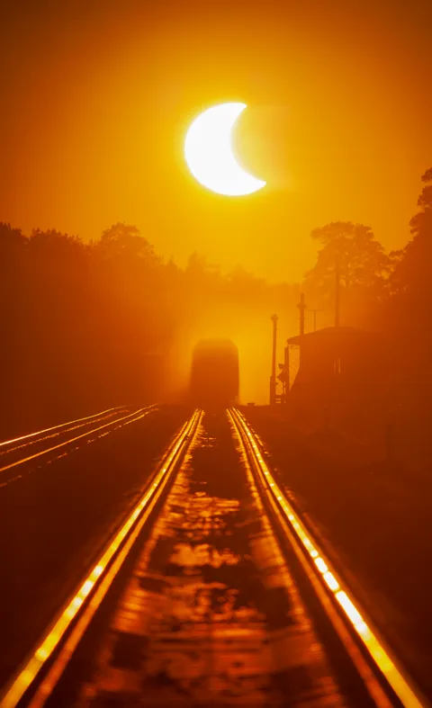I took a picture of the railway, train and the solar eclipse