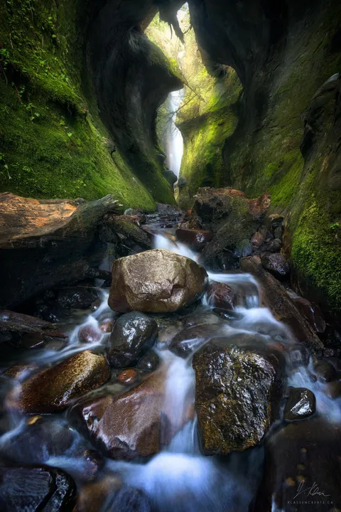 One of the coolest places I've been. A waterfall feeding into a mossy rock passage on Vancouver Island, BC [OC][1600x2400]