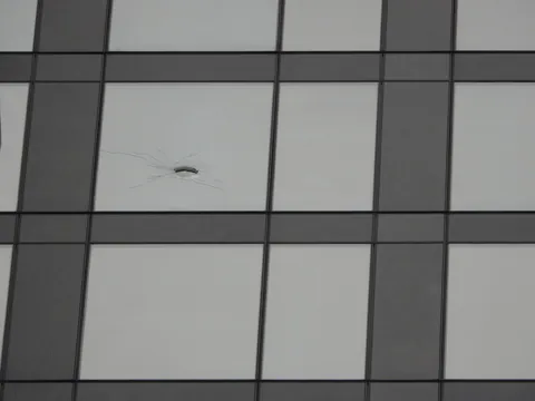 What can this giant hole on the 31st floor of my apartment building be? Woke up to a HUGE hole on the exterior window, there's no building in front of us and the terrace is on 12th floor. WTF is this???