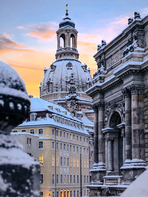 Snow-covered dome of the Frauenkirche seen beyond the Renaissance Revival Dresden Academy of Fine Arts building, Dresden, Saxony, Germany.