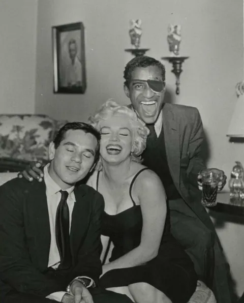 Sammy Davis Jr throws a party (1954). Sammy had just lost his eye in a car accident and had to wear an eyepatch, so others joined in. You may recognize some other famous faces.