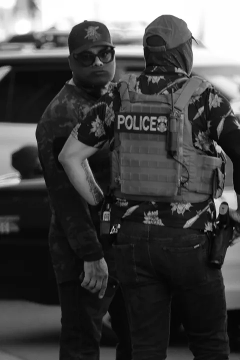 LAPD won’t enforce mask ban; here’s ICE in a POLICE mask, lounging on an LAPD car during arrest [OC]