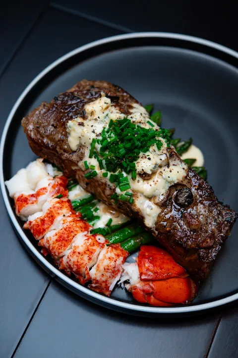 Homemade surf and turf with blue cheese pepper sauce on buttered asparagus.