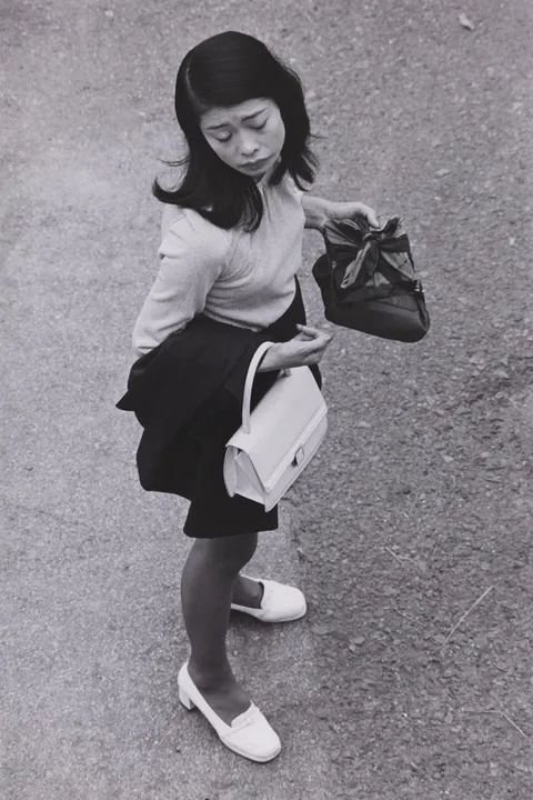 In 1974, Masahisa Fukase photographed his wife, Yōko Wanibe, every morning from the window of their apartment in Tokyo as she left for work.