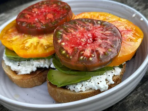Heirlooms from our garden, avocado, organic cottage cheese on sourdough toast 🤤