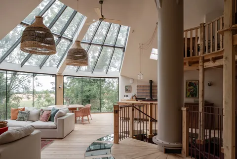Open living and kitchen space full of natural light in a circular house, Knebworth, Hertfordshire, England [1597x1067]