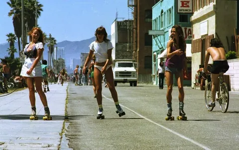 Venice Beach California during the late 1970s roller skate craze. Still has some 70s vibe but you can feel the 80s coming.