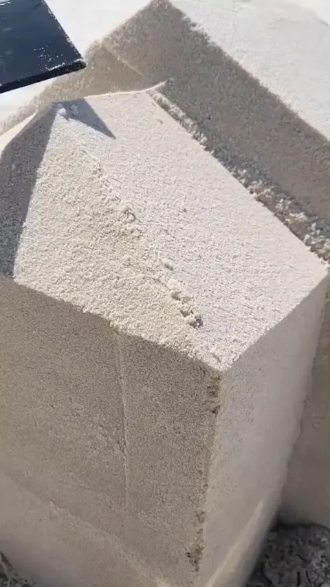 Building a sand sculpture.