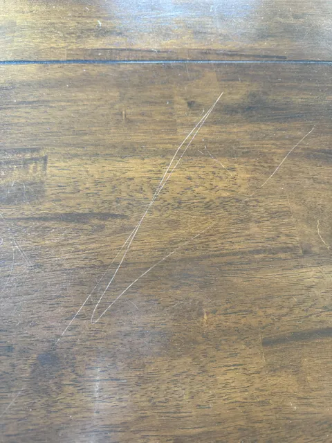 Mother in law scratched my beautiful wood dining table.