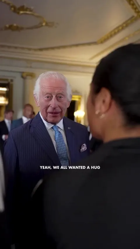 The New Zealand Black Ferns giving King Charles a hug