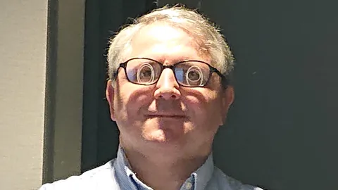 The ring mirror in my hotel bathroom reflects differently off my glasses since each eye has its own prescription.