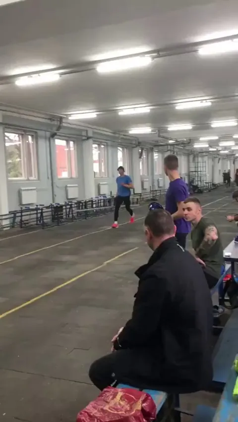 Competitive firefighter climbs up ladder.