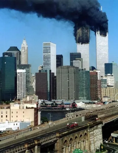 9/11/2001- The last known photograph of Ladder 118 as it crosses the Brooklyn Bridge. All 118’s firefighters would be killed in the collapse, found together in a stairwell 