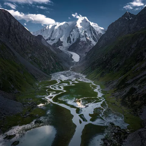 I am currently in Kyrgyzstan exploring mountains and took this shot of Karakol Peak (5200m+) a few days ago in the Karakol Valley, Kyrgyzstan. [1920x19200](OC)