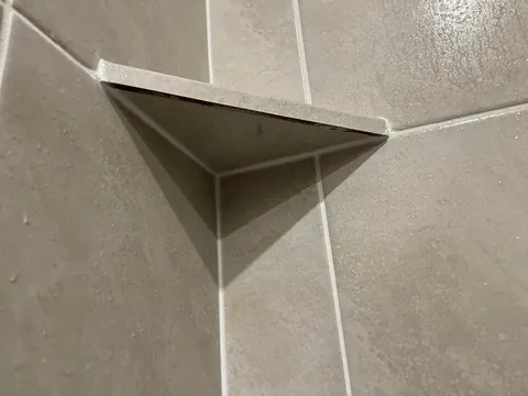 How is this shower shelf made from tile secured?