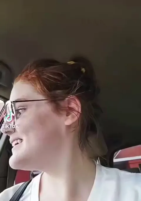 A woman enjoys being cussed at by a kid