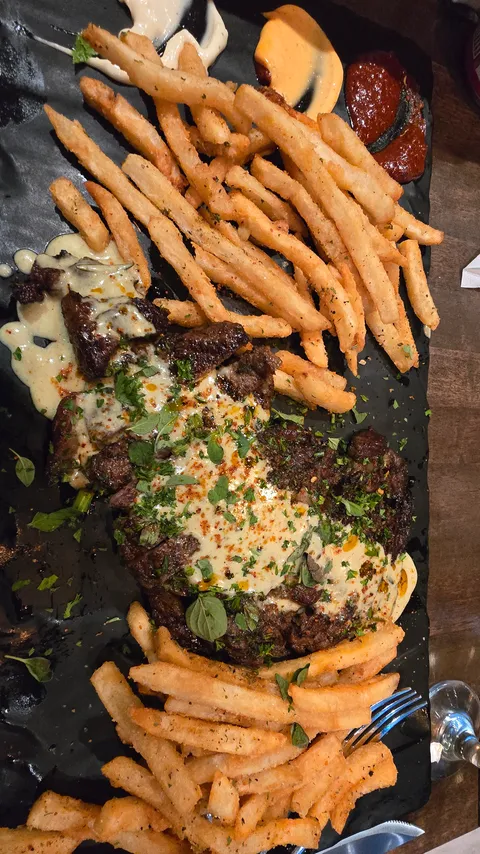 [homemade] steak with fries and a variety of sauces on the side