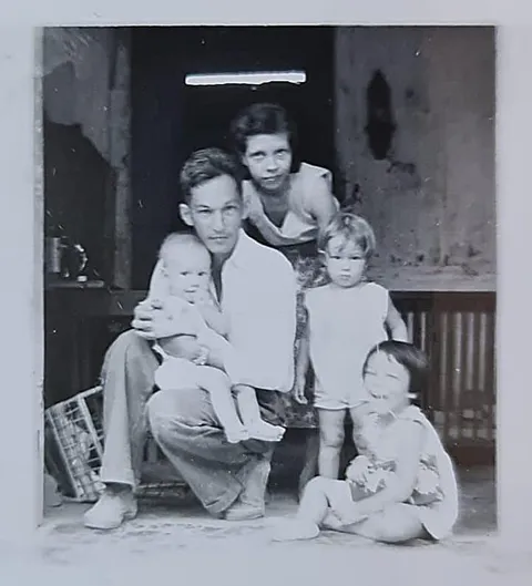 My grandparents on the front porch with 3 (eventually 10) kids. ~1954