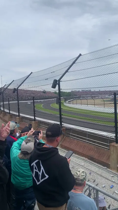 Helicopters do a lap with the cars before the Indianapolis 500