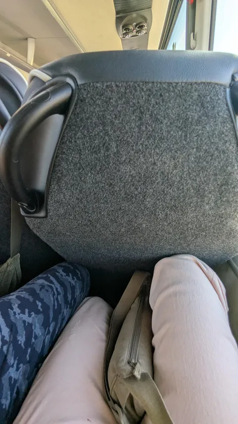 Old lady reclined her seat fully in a bus. I am 5ft tall and the seat is still close to my knees.