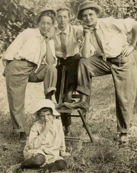 A group of Men and Women goofing around and switching clothes C 1910.