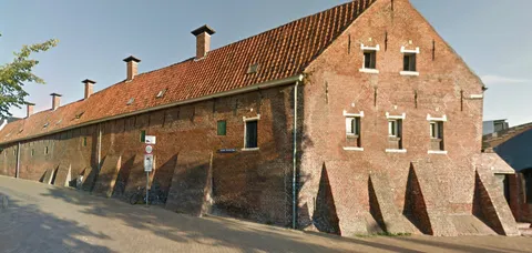 What is the reason for the brick slopes against this building?