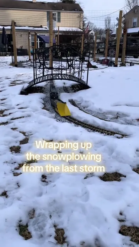 Toy train plowing the snow from its tracks