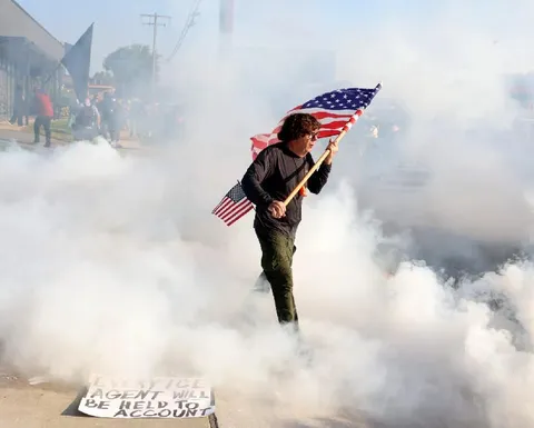 Curtis Evans, vet, carries flag through gas by federal officers ICE facility Broadview, IL 9/19/25