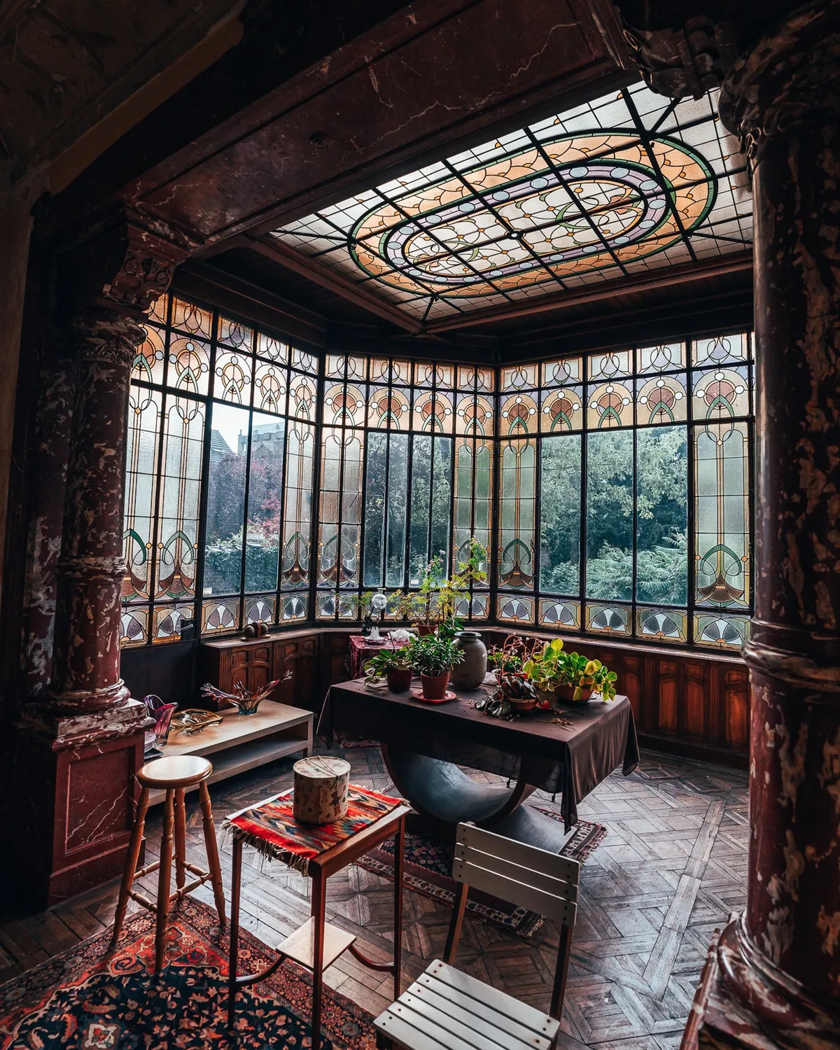 Winter garden room with stained glass windows in the 1908 Art Nouveau Maison des médecins, Charleroi, Wallonia, Belgium.