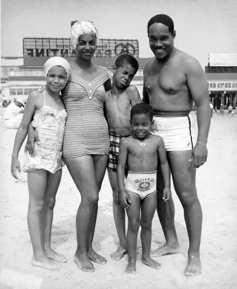 A mostly happy family outing at Chicken Bone Beach, the segregated section of Atlantic City's beach area, New Jersey, 1950s (photographed by John W. Mosley)