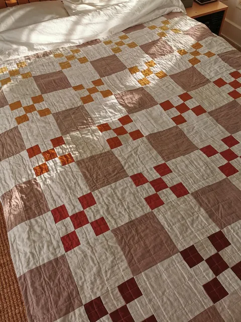 I taught myself to sew to make a cozy fall quilt for my bed. 90% thrifted fabric