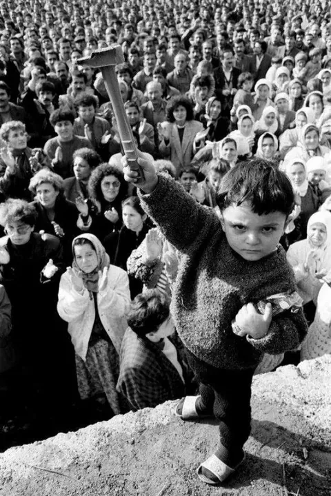 A young Turkish boy raises up a hammer during a solidarity rally for the 42,000 miners on strike in the Zonguldak coal fields, 1990.