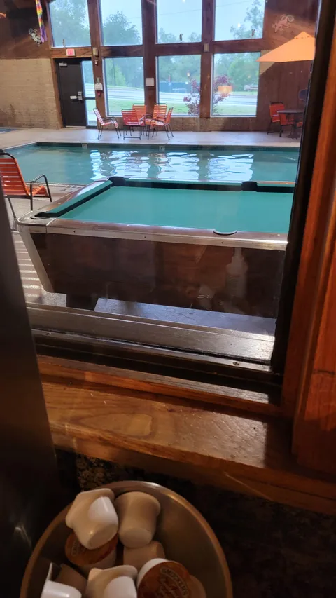 Hotel I'm staying at has a pool table in the swimming pool room.
