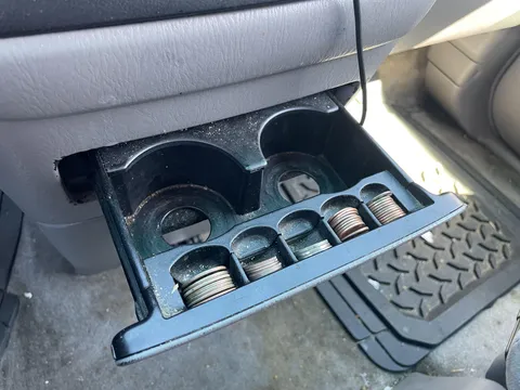 I just discovered that my van has slots for spare change in the cup holder.
