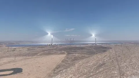 China's twin solar thermal towers. Molten salt stores the heat to produce electricity.. looks straight out of a sci-fi movie