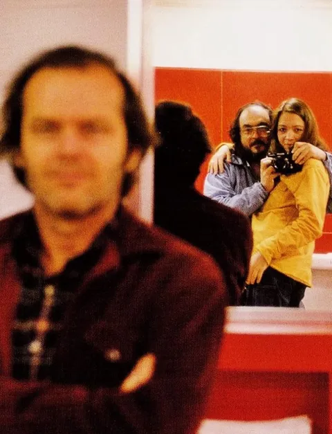 Stanley Kubrick taking a mirror selfie with his daughter while Jack Nicholson thought it was a photo of him on the set of The Shining, 1980.