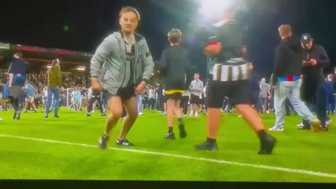 (Great Kneeslide) Grimsby town supporter celebrates the win over Manchester United