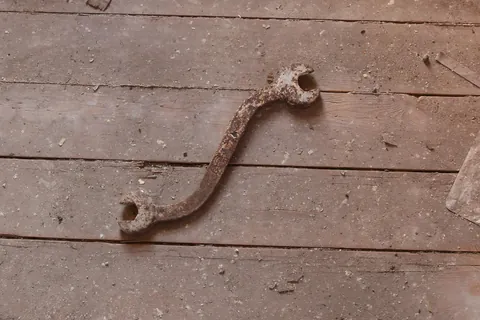 Old timey curved wrench found on the floor of an abandoned factory in Wisconsin.