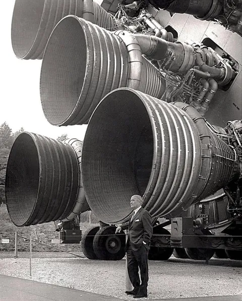 Dr von Braun stands beside the five F-1 engines of the Saturn V dynamic test vehicle, now on display at the Space and Rocket Centre in Huntsville, Alabama.